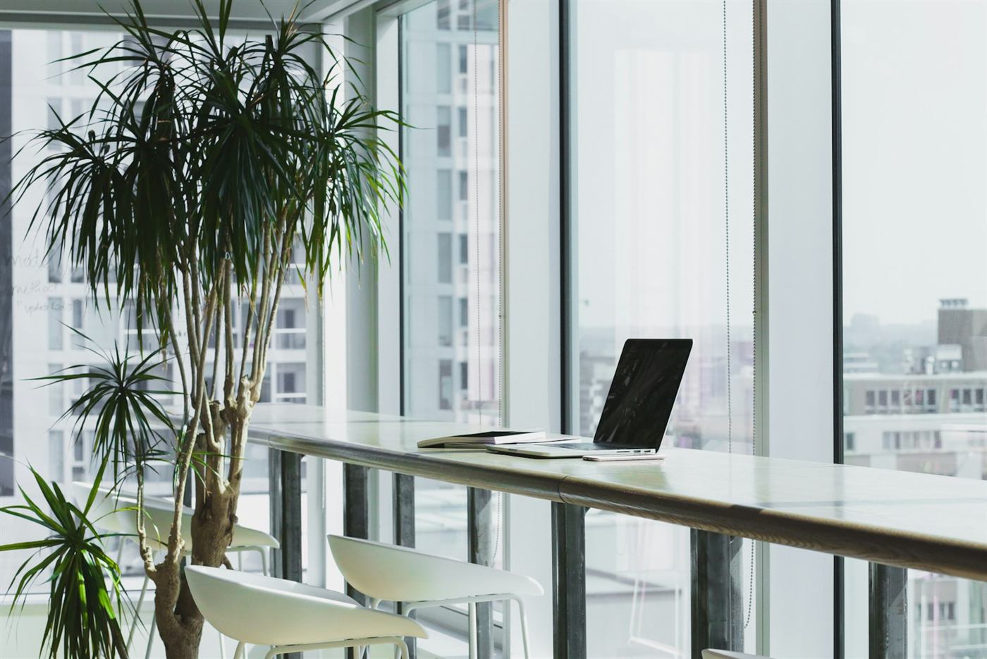 Bright, modern office workspace with desks and natural light.